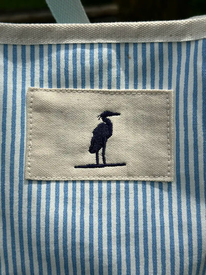 Up close picture of the Heron Icon that is stitched into a patch located in the top right corner of front of the bag. The bag is made of strong canvas. Great for the beach or the boat. 