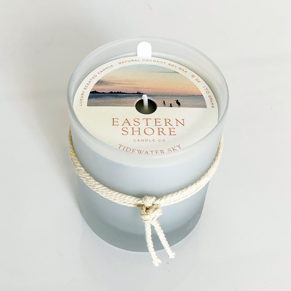 Tidewater Sky candle illustration, Showing the water with heron in the foreground Eastern Shore Co, Hand Poured candles in very small batches,  Tidewater, dewy air, sea salt, cedar wood scent, on the dock, waterview, ozone scent, watery scent, Scented candle, coconut soy wax, coastal candle, eastern shore, Chesapeake Bay, luxury candle, hand-poured, Maryland, Virginia