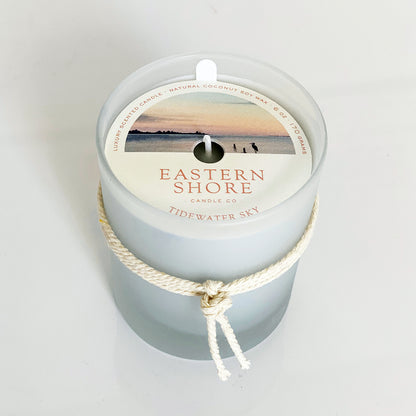 Tidewater Sky candle illustration, Showing the water with heron in the foreground Eastern Shore Co, Hand Poured candles in very small batches,  Tidewater, dewy air, sea salt, cedar wood scent, on the dock, waterview, ozone scent, watery scent, Scented candle, coconut soy wax, coastal candle, eastern shore, Chesapeake Bay, luxury candle, hand-poured, Maryland, Virginia